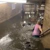 Subway Commuters Wade Through Waist-Deep Waters As Heavy Rainfall Triggers Flash Floods